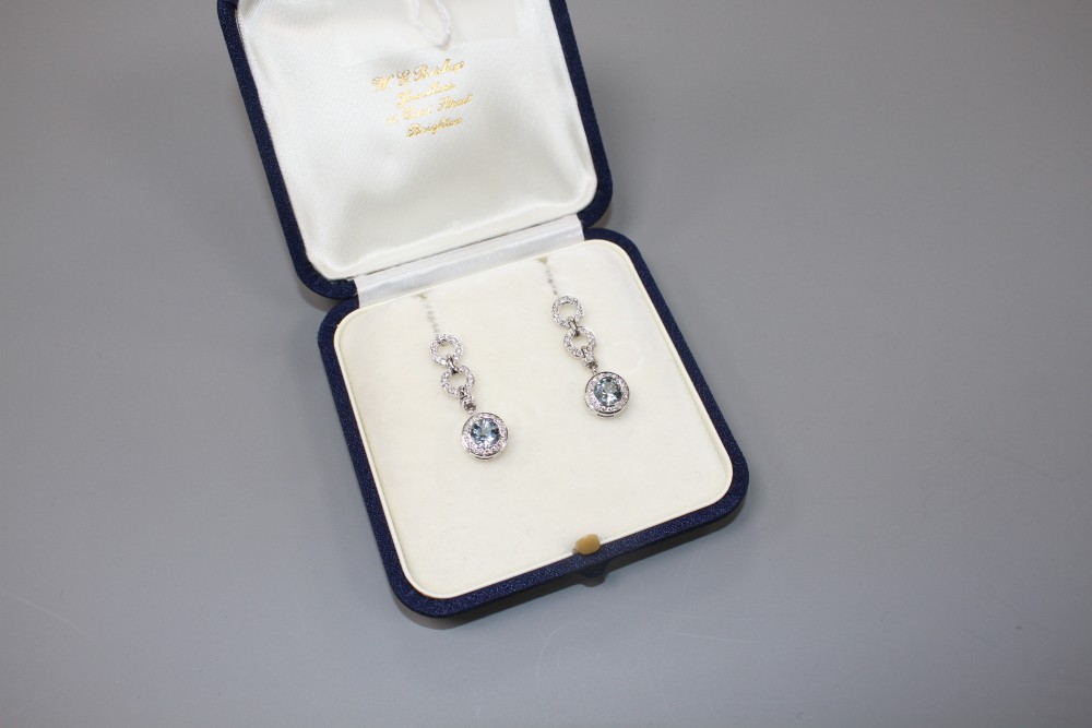 A modern pair of 18ct white gold, aquamarine and diamond set drop earrings, drop 29mm, gross weight 7.5 grams.